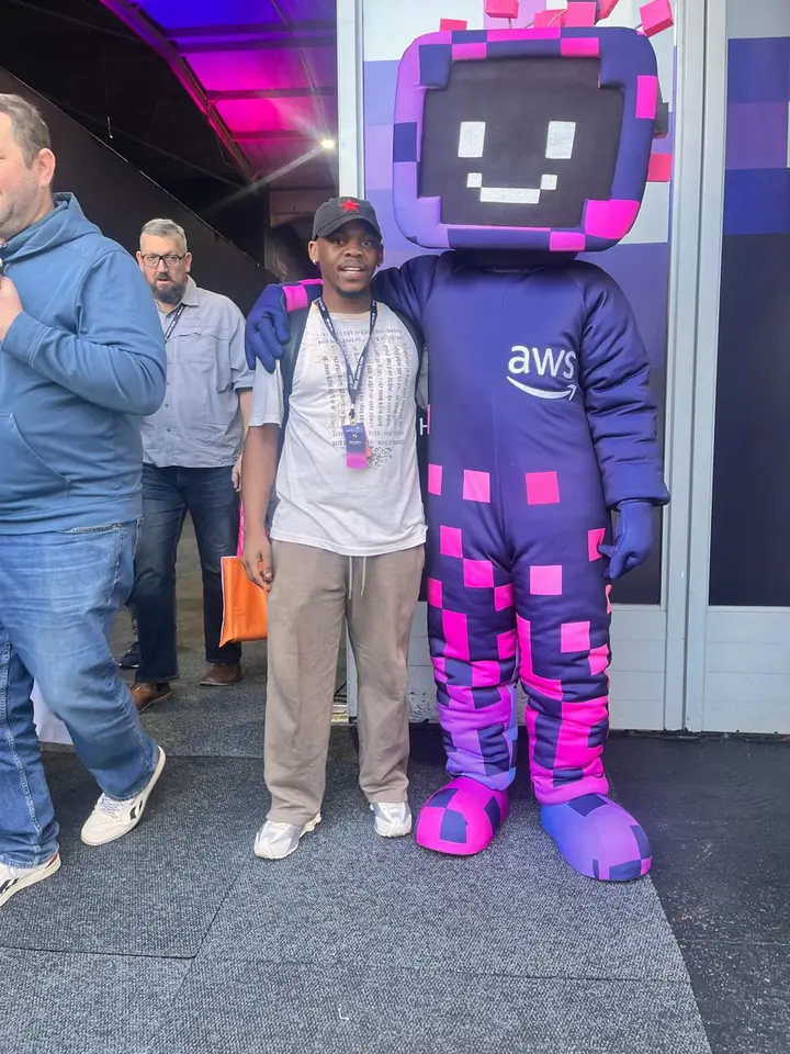Maredi Manyama standing with the AWS mascot at the AWS Summit