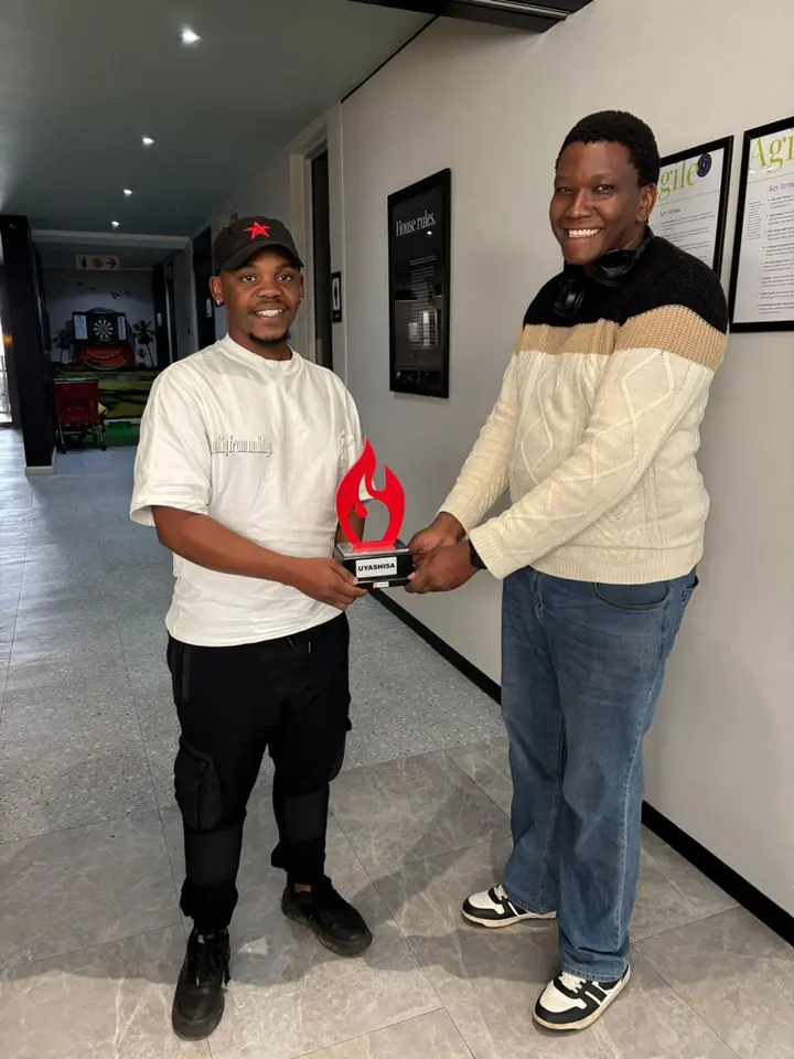Maredi Manyama receiving the Uyashisa Employee of the Month trophy